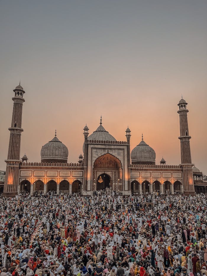 A vibrant crowd gathers at Jama Masjid, Delhi, for a sunset celebration.